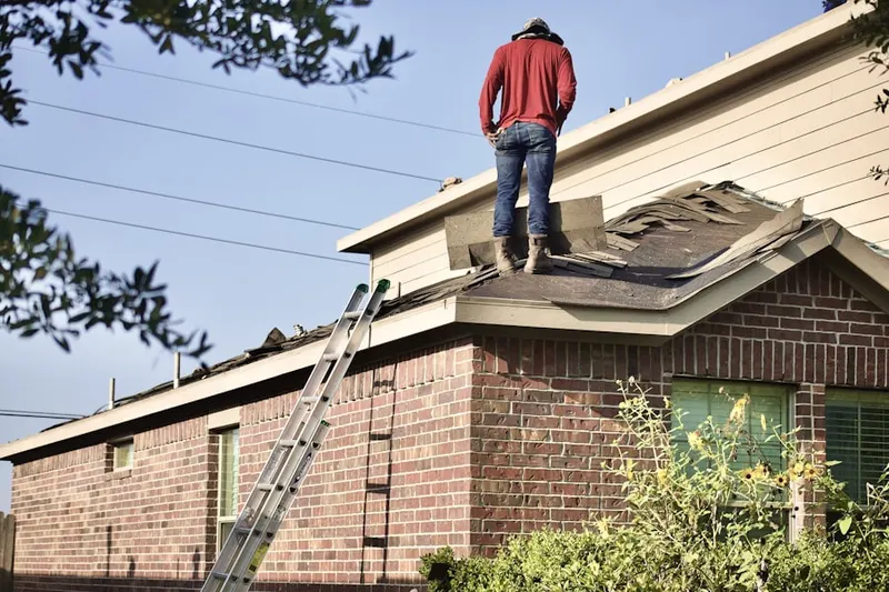 Professional roofer working on a residential roof in Fisher Corners